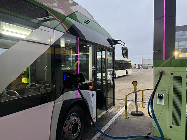 Electric bus connected to a PowerBoost  at a public transit depot